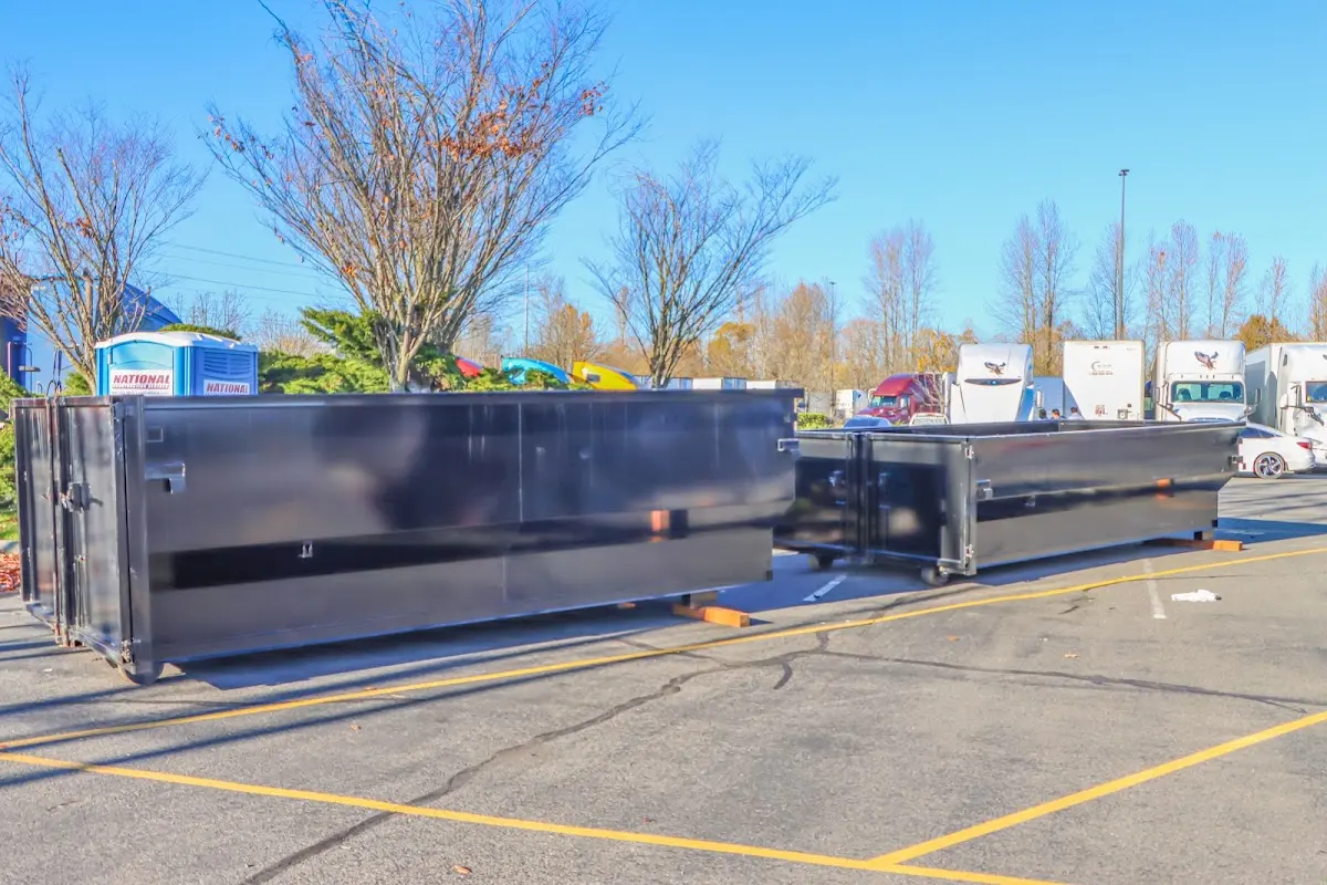 Professional dumpster rental service with roll-off container on residential driveway in Menasha